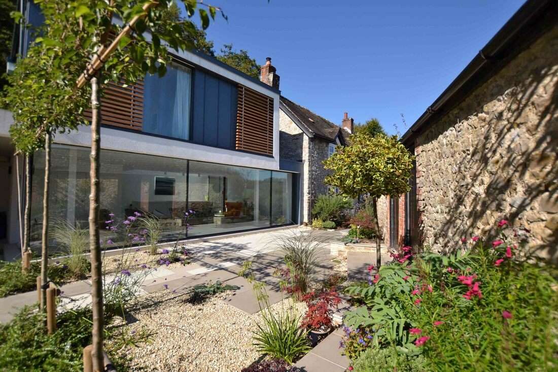 Glazed extension linking period stone buildings